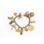 A charm bracelet, the curb-link bracelet stamped '9 .375', suspending a collection of gold and
