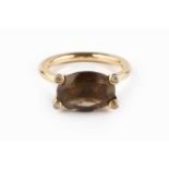 A smoky quartz and diamond dress ring, the oval mixed-cut smoky quartz in four claw setting,