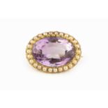 An amethyst and half pearl cluster brooch, the oval mixed-cut amethyst in pinched collet setting,