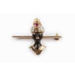 An enamel and gem set blackamoor bar brooch, heightened with black and white enamel, his turban with