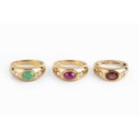 Three gem set dress rings, the first set with an oval cabochon ruby between two circular-cut white