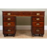 A Victorian mahogany pedestal desk with red tooled leather top and nine drawers about the knee, with
