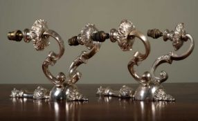 A pair of silvered two-branch metal wall lights, 30cm high (2)Scratches to the silver finish, in