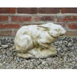 A cast reconstituted stone garden sculpture of a hare, 42cm long x 28cm highWeathered, otherwise