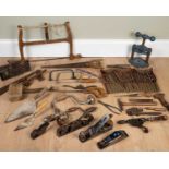 A collection of carpentry tools to include saws, clamps, measuring implements, trowels, and