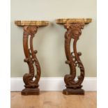 Two similar console tables, the faux marble painted shaped tops above scrolling carved oak supports,