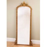 A giltwood and gesso framed pier glass, the egg and dart border with crest and floral swags, 62cm