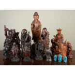 A group of modern Asian hardwood carved figurines to include various deities, the largest 45cm