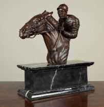 A bronze head and shoulders of a mounted jockey, on a marble base, 31cm wide x 13cm deep x 39cm