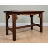 An Arts and Crafts pitch pine table with hardwood rectangular top, fluted legs and H-stretcher