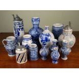 A collection of German salt glaze stoneware pottery comprising various jugs and tankards, the