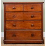 A Victorian mahogany chest of two short and three long drawers with turned handles and raised on a