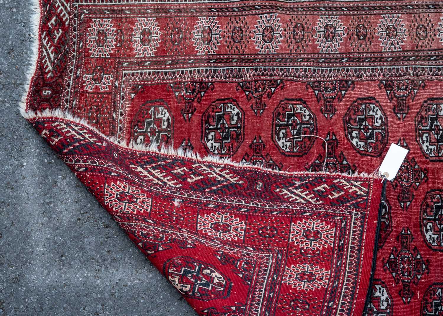 A red ground rug with all over geometric shapes within a brown and black banded border, 130cm x - Image 2 of 2