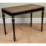 A Victorian ebonised rectangular side table with a brown leather inset top and four turned and