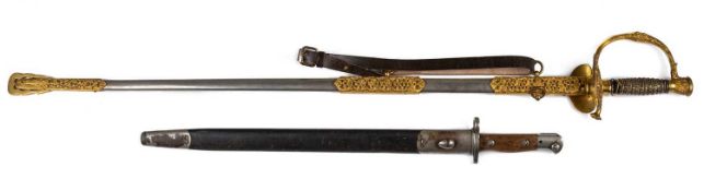 A gilt metal dress sword, with engraved scrolling decoration on the blade and scabbard, 97cm long,