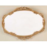 A modern giltwood oval wall mirror with ribbon tie and floral swag decoration, 87cm wide x 70cm high
