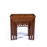 Nest of three Chinese tables each with a carved ruyi style tier, 55.5cm high x 56cm across x 48cm