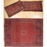 A red ground runner with central geometric pattern, 255cm x 65cm together with a red ground rug with