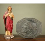 A pressed bronze plaque depicting Jesus in a crown of thorns, 35cm x 26cm; together with a carved