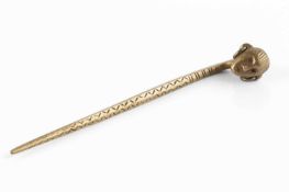 An antique gilt metal pin, with head finial and scratch work design with makers mark to back,