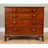 A George III mahogany chest of two short over three long graduated drawers with turned handles on