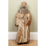 An antique, possibly 17th century, continental carved pine sculpture depicting a monk dressed in his