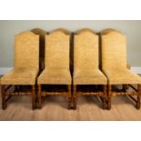 A set of eight high back dining chairs with upholstered seats and backs, on oak frame and turned