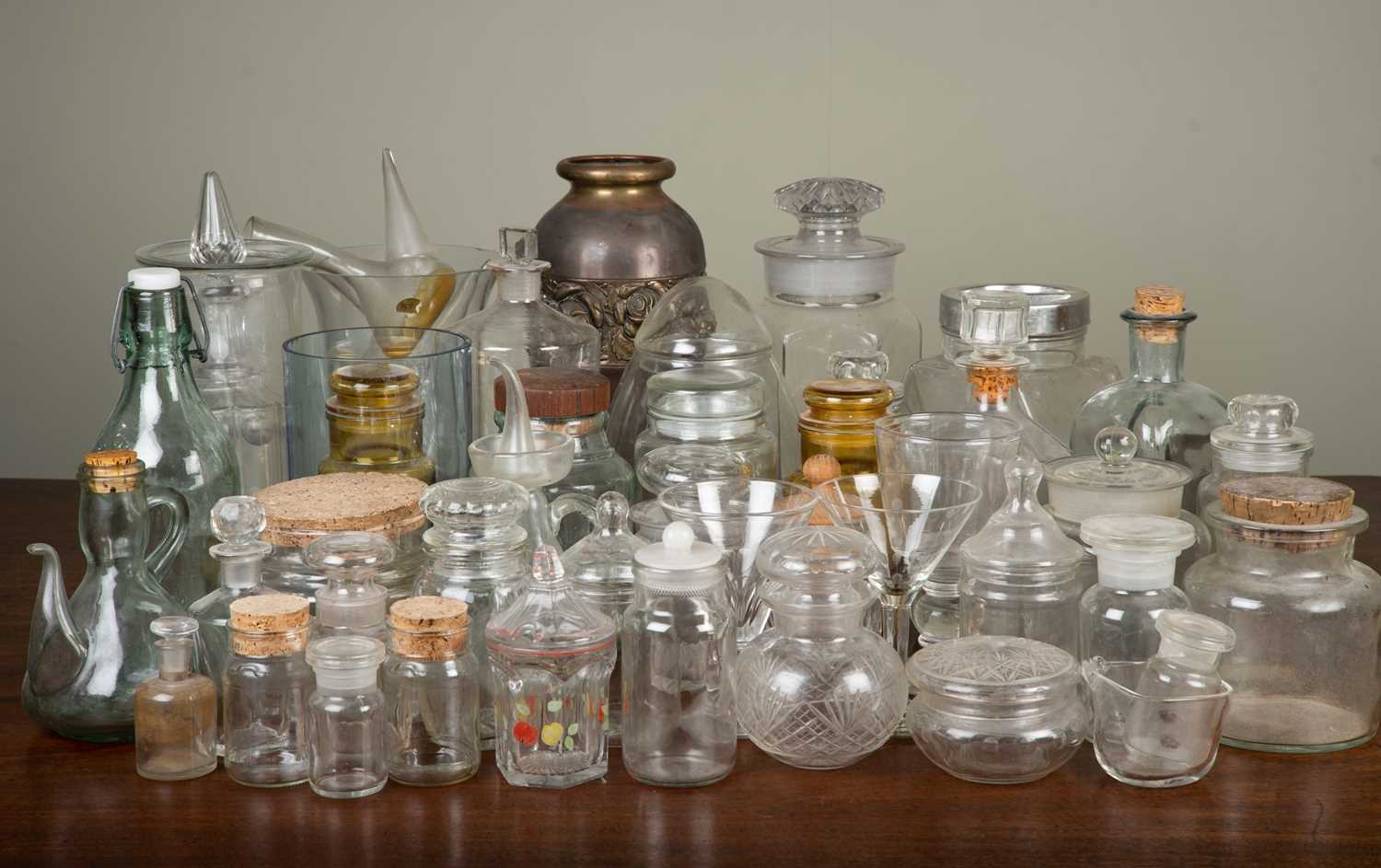 A large collection of glassware to include a set of six cocktail glasses, various storage jars,