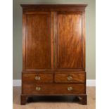 A mahogany linen press, with a pair of cupboard doors over two short and one long drawer, with brass