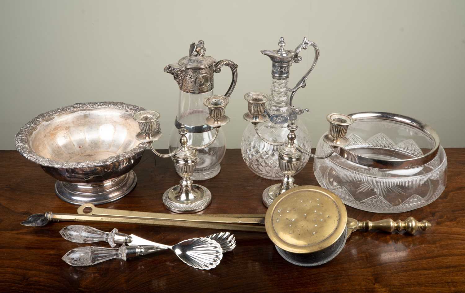 Two silver mounted cut glass claret jugs, a pair of two branch silver plated candelabras, a pair