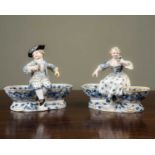 A pair of Meissen porcelain figural salts, each double bowled salt with a seated child on top and on