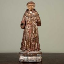 A carved figure of a monk, with faded painted decoration on plinth base, 21cm highLosses to both
