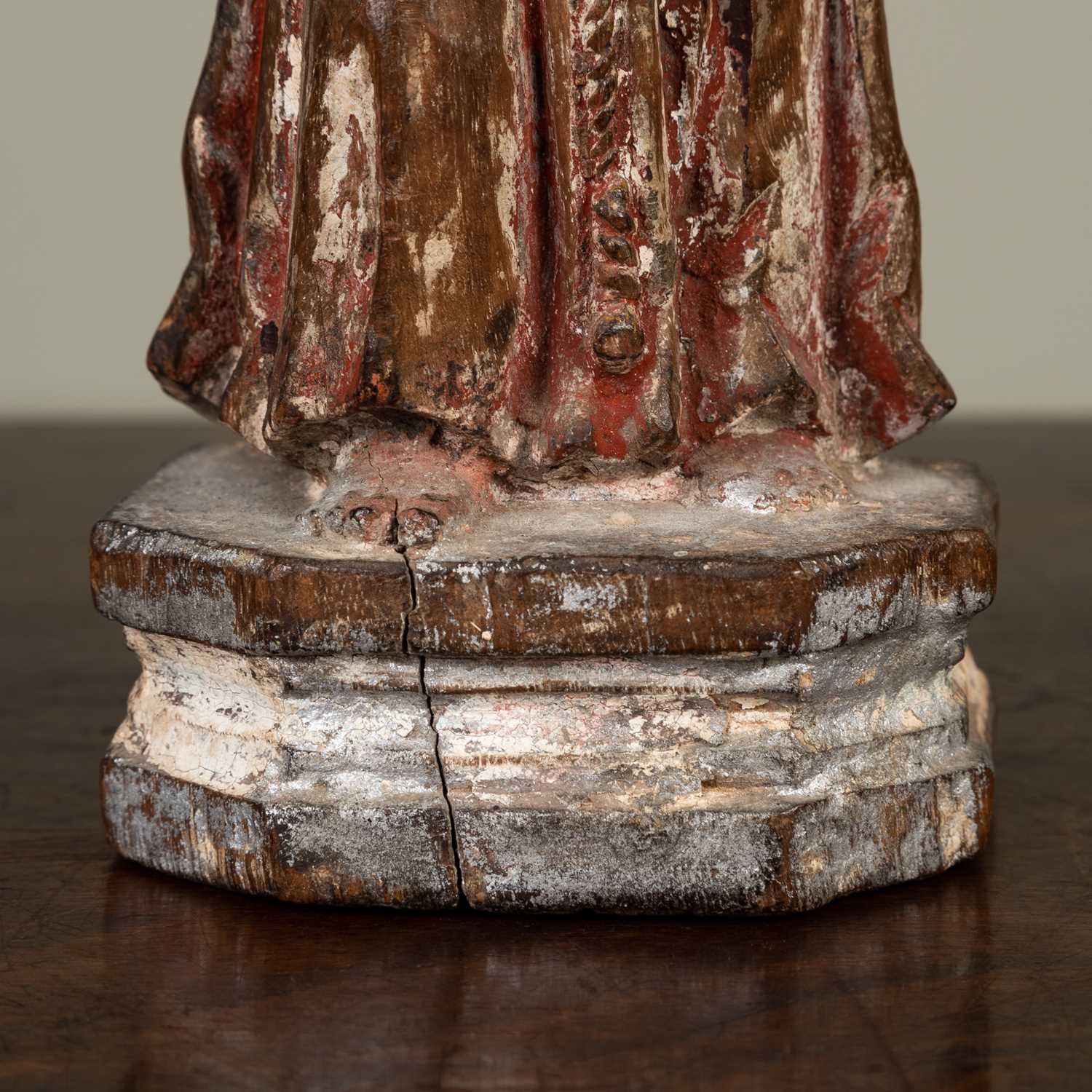 A carved figure of a monk, with faded painted decoration on plinth base, 21cm highLosses to both - Image 2 of 3