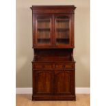 A 19th century French mahogany bookcase cabinet with twin glazed doors above two short drawers and