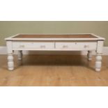 A white painted low table, with pair of drawers below leather inset top, on turned supports, 136cm