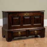 A miniature oak mule chest, with triple panelled front over pair of short drawers, on bracket