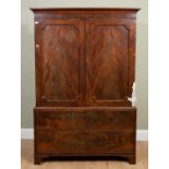 A mahogany linen press the pair of doors over two drawers, on bracket feet, in need of