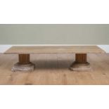 A low marble topped occasional table on carved wooden column shaped supports, 46cm wide x 124.5cm