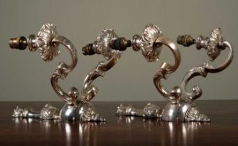 A pair of silvered two-branch metal wall lights, 30cm high (2)Scratches to the silver finish, in