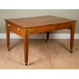 A pine kitchen table on tapering supports and castors, 105cm deep x 137cm long x 78cm highSome