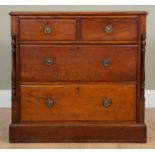 A mahogany chest of two short over two long drawers, with glass ring pull handles and column inset