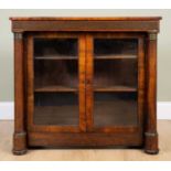 A Victorian rosewood bookcase with inset decorative brass banding, outset columns to either side and