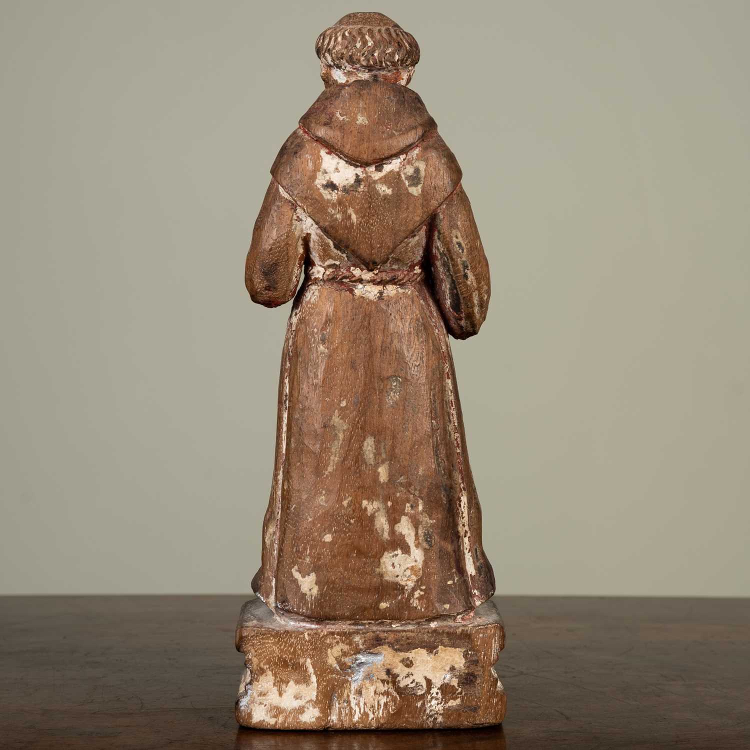 A carved figure of a monk, with faded painted decoration on plinth base, 21cm highLosses to both - Image 3 of 3