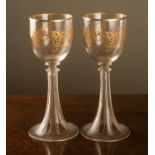 A pair of 19th century gilt decorated tall glasses with trumpet rimmed bases, 23cm high (2)Some