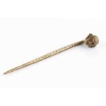 An antique gilt metal pin, with head finial and scratch work design with makers mark to back,