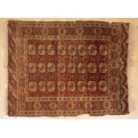 A red ground Tekke Turkman rug 130cm x 170cmwear, some losses to edges.