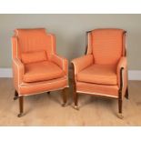 Two Edwardian armchairs, one with a rosewood frame and wing back, standing on square tapering