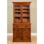 A Victorian mahogany bookcase cabinet the pair of glazed doors over shelves, on top of drawer with