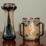 A late Victorian Doulton Lambeth stoneware tyg with silver rim and decorated with athletes amongst