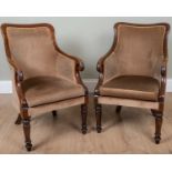 A pair of early Victorian mahogany framed library armchairs, with scrolling arm terminal and